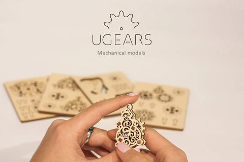 Fidget Tribiks Self Assembly Kit For Stress Relief And Fun Four Mini Wooden Mechanical Gear Models Easy Snap Off Parts Family Friendly STEM Toy For Adults And Kids 5 Plus Premium Wooden Construction, hand holding assembled wooden gear model