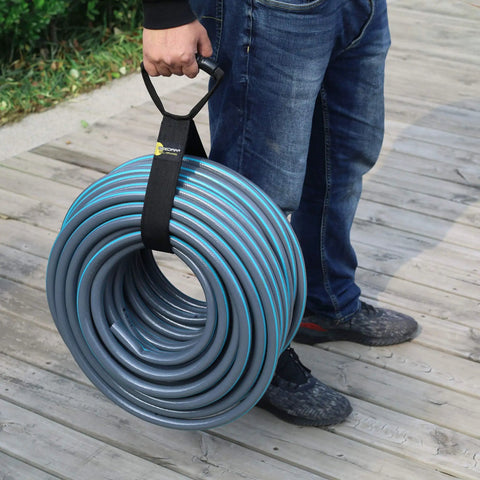 Person holding coil with Eight Pack Heavy Duty Extension Cord Organizer With 60 Lb Capacity For Cords Hoses And Tools Adjustable Strap System With Carabiners For Easy Garage Storage And Organization