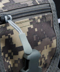 Close-up of a zipper with an attached zipper pull tab on camouflage fabric, featuring Yellow 20 Pack Zipper Pull Tabs With 1.6 Inch Cord And 2.6 Inch Total Length Durable Non Slip PU Grip Zipper Extensions For Backpacks Jackets Luggage Purses And Handbags.