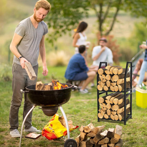 Man using barbecue grill with Two Tier Firewood Rack With 3 Hanging Hooks Heavy Duty Steel Wood Holder nearby in a garden setting