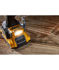 Close-up of 20V Max XR Brushless Cordless Drill And Driver Kit With Two Batteries And Charger showcasing base and LED light on wood surface.