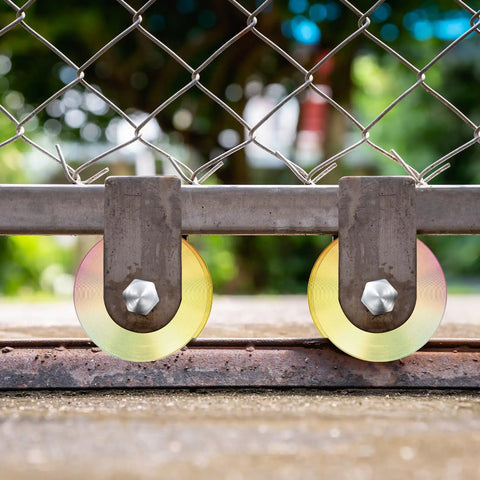2 Sets Rock Solid 4 Inch V Groove Gate Roller Wheels Hardened Steel Double Ball Bearing 3000 lbs Capacity mounted on gate track.