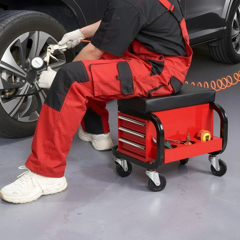 Mechanic using Tool Box With Built In Creeper Seat And Three Drawer Heavy Duty Tool Chest On Four Rolling Casters For Garage Shop Roller Seat And 350 Lb Capacity Sturdy Steel Construction for wheel repair.