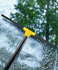 Built Tough 24 Inch Floor Squeegee With 60 Inch Extendable Handle wiping water from glass window