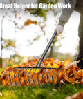 Heavy Duty Garden Rake With 11 Stainless Steel Tines And 68 Inch Handle For Leaves Thatch Debris Clean Up in use on autumn leaves
