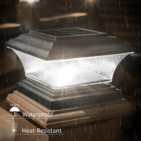 Solar Post Cap Lights For Outdoor Deck And Fence LED Post Caps With 9 Lighting Modes Including Bright White And RGB Color Options Fixed And Cycling Colors Fits 4x4 Or 5x5 Wooden Posts Black 6 Pack showing a lit black post cap in rain, highlighting waterproof feature.