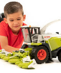 Young boy playing with CLAAS Jaguar 980 Field Chopper 1 16 Scale Model With Realistic Cab Details And Openable Doors A Premium Farm Toy