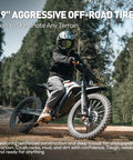 19" aggressive off-road tires on Heavy Duty Kickass 9000W Peak Motor Electric Dirt Bike in rugged terrain for superior traction.