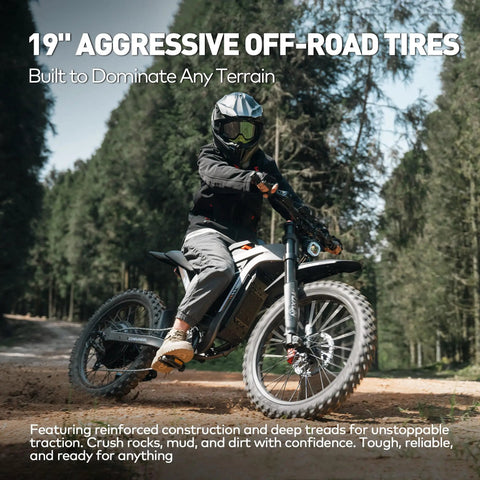 19" aggressive off-road tires on Heavy Duty Kickass 9000W Peak Motor Electric Dirt Bike in rugged terrain for superior traction.