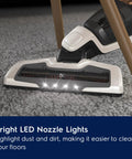 Electrolux Ergorapido cordless vacuum cleaner head, front view, with LED nozzle lights on carpet.