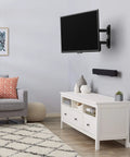 Built Tough Full Motion TV Wall Mount With Effortless Swivel And Tilt Angles For Twenty Six To Fifty Five Inch Screens Handling Up To Eighty Pounds mounted above a white entertainment center
