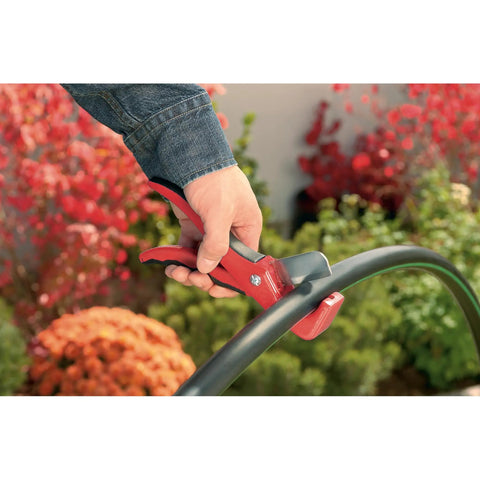 Automatic Garden Box Irrigation System Kit With 64 Sq Ft Coverage detail showing a hand using quick connect tool on hose