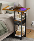 C Shaped Side Table With Charging Station And Wheels For Bedroom Living Room And Home Office Type C USB Ports And Two AC Outlets To Charge Up To Four Devices Plug And Play beside bed