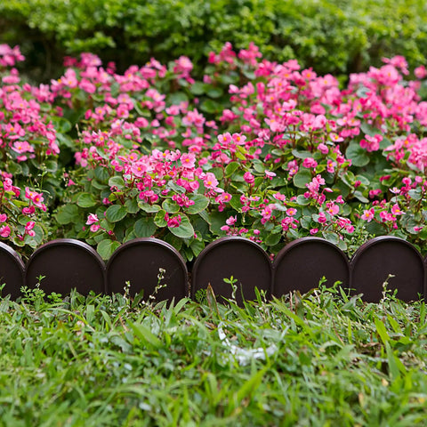 Brown PP plastic half-round garden border edging panels in flower bed showcasing lawn edge fence barrier in yard landscaping