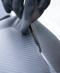 Close-up of vinyl cutter trimming vinyl on car, part of the 9 In 1 Vinyl Wrap Tools Kit With Heat Gun For Car Wrapping And Window Tinting