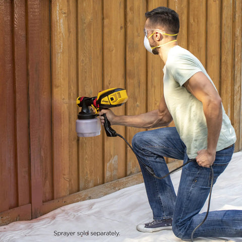 Man using iSpray Front End Nozzle for HVLP Sprayers on wooden fence, delivering concentrated spray pattern, sprayer sold separately.