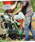 Farmer installing Adjustable Seed Tube Kit For Wheat And Corn on a planter, featuring sturdy plastic seeder tube for easy installation.