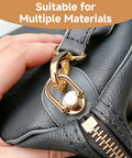 Gold D Ring Hardware Kit For Purse Straps With 360 Rotatable D Rings attached to a black leather bag, close-up view.