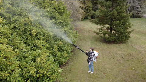 Person using Backpack Mosquito Fogger With Turbo Pump M915 Cold Fogger And Mister Duster For Outdoor Pest Control in garden