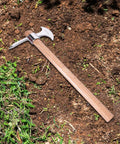 Stainless Steel Pickaxe Gardening Tool For Heavy Duty Digging And Soil Breaking on dirt ground with wood handle visible