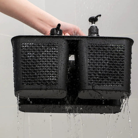 Close-up of hand holding black Portable Shower Caddy Basket With Handle For Bathroom And Kitchen Storage in shower with water running