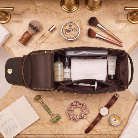 Top Shelf Genuine Buffalo Leather Toiletry Bag For Men And Women Brown Travel Organizer With Waterproof Inner Compartment storing grooming items.
