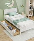 Solid Wood Twin Platform Bed With Two Smooth Rolling Storage Drawers And A Clean White Headboard in a cozy kids' bedroom setup.