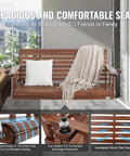 Wood Porch Swing 5.5Ft With Heavy Duty 880 Lb Capacity For Outdoor Patio Garden Hangout Built To Last Durable Fir Wood With Galvanized Chains Weatherproof Brown shown installed with cushion and throw blanket.