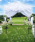 Outdoor wedding setup with 62 Inch Outdoor Shepherds Hook Bird Feeder Pole With 5 Prongs Base used for floral arrangements on green lawn.