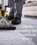 Carpet extractor cleaning carpet with foam in recovery tank