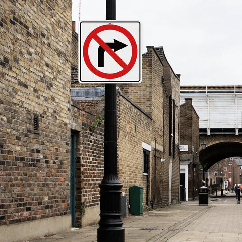 Large No Right Turn Sign 18 x 18 Inches High Visibility Reflective Aluminum Engineered Grade Safety Sign For Night Driving And Daytime Traffic In Streets Parking Lots And Work Zones mounted on a pole in a brick alley