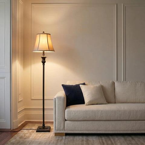 Sophia LED Floor Lamp Tall Mid Century Modern Style with Bell Shape Fabric Shade Bronze Finish next to beige sofa in living room