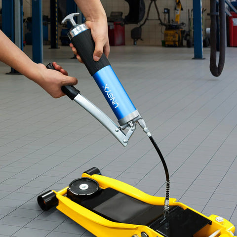 8000 PSI Heavy Duty Lever Action Grease Gun Kit With 14oz Aluminum Barrel in use on floor jack