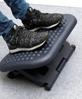 Person using Under Desk Foot Rest For Ergonomic Comfort, Height Adjustable From 3.25 To 6.25 Inches, Massage Textured Surface, Black