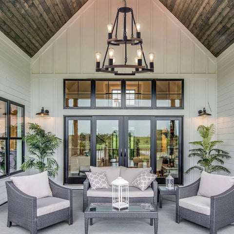 Wagon Wheel Chandelier 9 Light Farmhouse Ceiling Light in Black Metal and Wood Frame above patio seating area, rustic decor