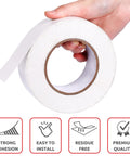 Hand holding Two Sided Rug Tape That Grips Like Crazy For Area Rugs And Floor Mats Easy Peel Adhesive For Wood Tile And Textured Surfaces Non Slip Carpet Tape White 2 In By 10 Yd roll