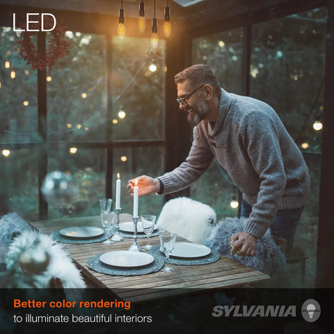 Man setting dinner table under LED B10 Light Bulbs 300 Lumens 2700K Soft White Non Dimmable 4.5W Clear Glass in cozy interior