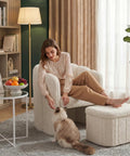 Super Snug White Barrel Accent Chair With Storage Ottoman In Thick Teddy Boucle Fleece, plush lounge seating with a woman and a cat.