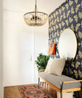 Boho Wood Bead Chandelier With Five Lights And 20 Inch Diameter hanging in modern hallway with butterfly wallpaper and bench seating