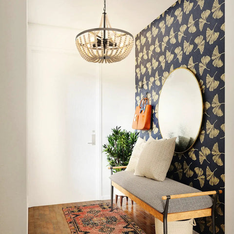 Boho Wood Bead Chandelier With Five Lights And 20 Inch Diameter hanging in modern hallway with butterfly wallpaper and bench seating