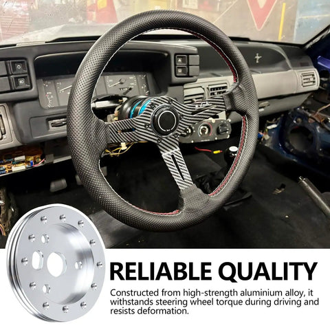 Half Inch Steering Wheel Hub Adapter Spacer Converts Six Hole To Three Bolt Pattern With Rugged Bolts next to a textured steering wheel.
