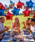 Group enjoying outdoor party with Red White And Blue Mylar Balloons Set For 4th Of July Patriotic Arch Kit With Star Balloons