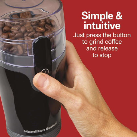 Hand pressing button on Fresh Grind Electric Coffee Grinder For Beans, Spices And More with stainless steel blades, black color.