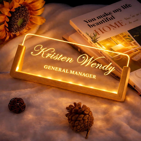 Custom Desk Name Plate With LED Wood Base, Light Up Acrylic Name Plate For Desk And Office Sign, Personalize With Name Or Title displayed on soft fabric with decorative items and books