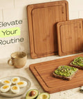 Top Shelf Wooden Cutting Boards For Kitchen Meal Prep And Serving With Deep Juice Groove And Sturdy Handles Real Deal Charcuterie Serving Tray And Tough Butcher Block For Steak Slicing And Daily Cooking Three Piece Set with bamboo boards and food.