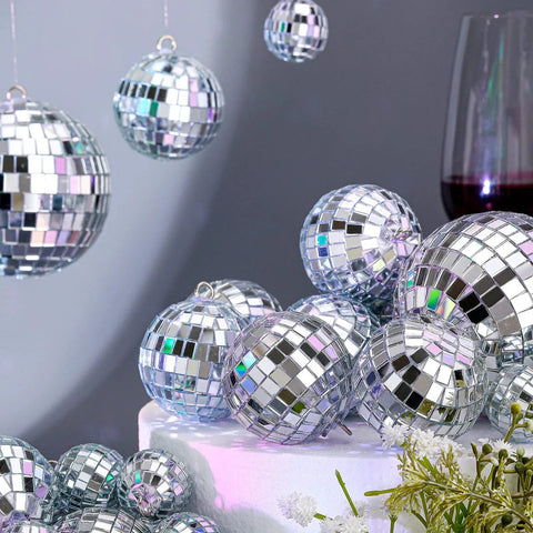 65 Piece Disco Ball Decorations Set With Mini Reflective Mirror Balls In Silver, Foam Core With Sequin Shine on table