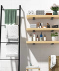 Floating shelves with Set Of 6 8 Inch Heavy Duty Hidden L Shelf Brackets For Floating Shelves Supports Up To 200 Pounds With Rustic Industrial Black Iron Finish Durable Steel Construction For Easy Mounting And Modern Home Or Workshop Use, holding towels and toiletries in a bathroom setting.