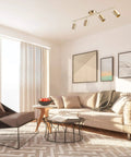 Pratt 4 Light Track Lighting In Matte Brass Gold With Pivoting Heads For Modern Glam Illumination in chic living room setting.