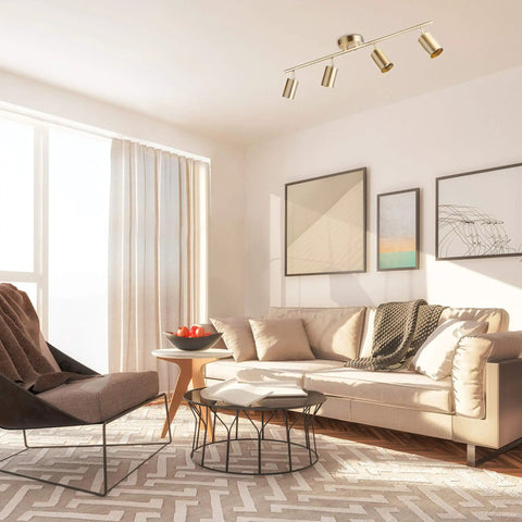 Pratt 4 Light Track Lighting In Matte Brass Gold With Pivoting Heads For Modern Glam Illumination in chic living room setting.