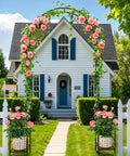 8 Foot Metal Garden Arch Trellis With Planter Boxes For Climbing Plants Outdoor Rust Resistant Backdrop Stand For Weddings Parties And Garden Decor Heavy Duty Pergola decorated with pink roses and greenery in front of a house